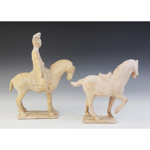 336 - A Chinese pottery model of figure riding a horse, possibly Tang dynasty, the horse raised on four le... 