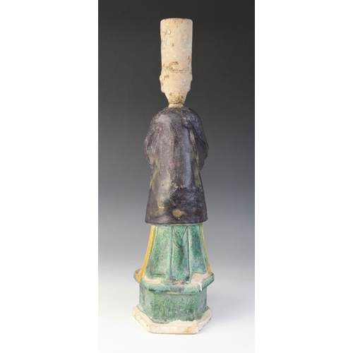 343 - A large Chinese Sancai glazed attendant, possibly Tang dynasty, modelled standing holding an offerin... 