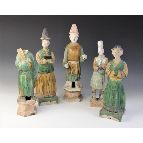 345 - Five Chinese Sancai glazed attendants, possibly Ming dynasty or later, each glazed in green and yell... 