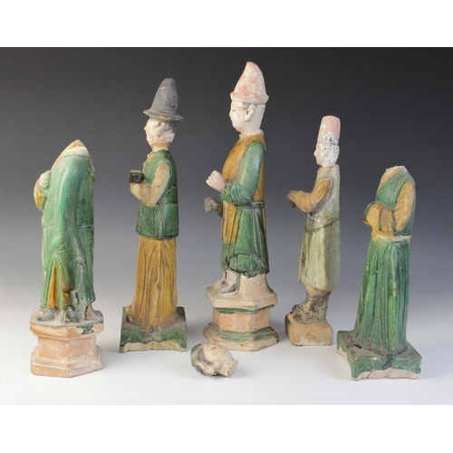 345 - Five Chinese Sancai glazed attendants, possibly Ming dynasty or later, each glazed in green and yell... 