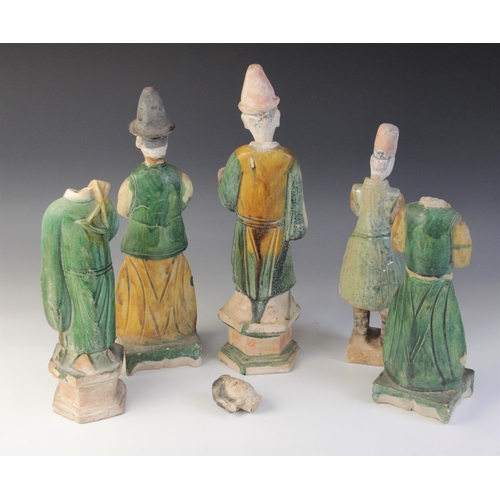 345 - Five Chinese Sancai glazed attendants, possibly Ming dynasty or later, each glazed in green and yell... 