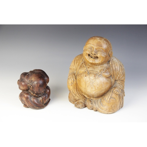 346 - An Eastern carved figure of a Buddha, modelled seated laughing, 25cm high with a Orang Malu carving,... 