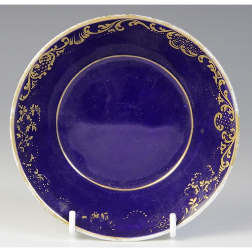 356 - A Sevres porcelain cup and saucer, 18th century, the straight sided cup with bleu lapis ground, fine... 