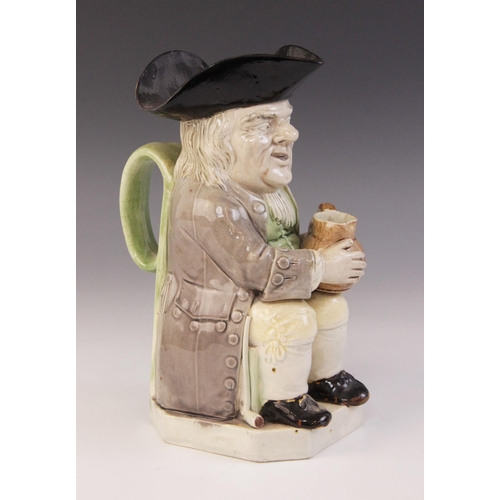 360 - A Staffordshire pearlware Toby Jug, circa 1790, of traditional form modelled holding a jug in both h... 