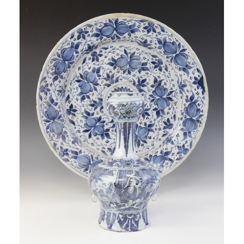 366 - A Dutch delft charger, 18th century, busily decorated in blue throughout with stylised flowers and f... 