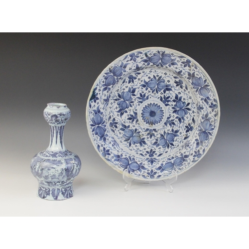 366 - A Dutch delft charger, 18th century, busily decorated in blue throughout with stylised flowers and f... 