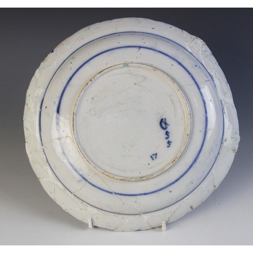 368 - A delft plate dated 1725, blue painted with a central lozenge with four stylised flower heads, initi... 