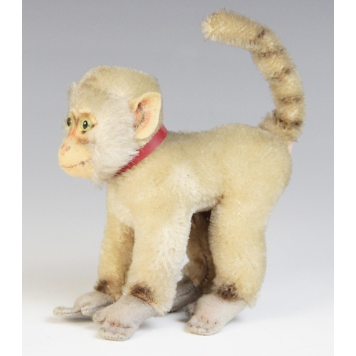 37 - A Schuco style novelty miniature orangutan, early 20th century, the mohair body with jointed arms an... 