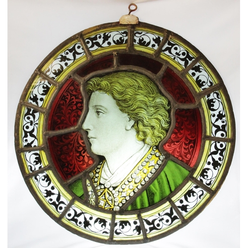 375 - An oval stained and painted glass portrait panel, 19th century, depicting a young gentleman in ornat... 