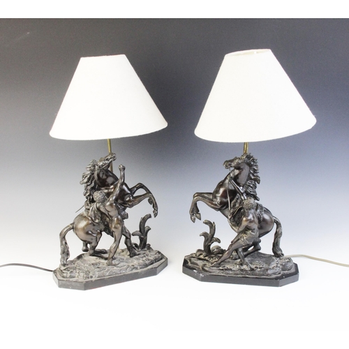 387 - After Guillaume Coustou, a pair of patinated bronze Marly horses, naturalistically modelled rearing ... 