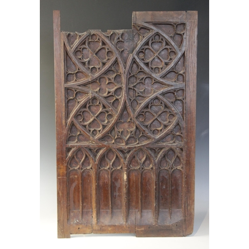 400 - Two early 16th century blind tracery carved panels, of quarteform and triform design, 66cm x 27.5cm ... 