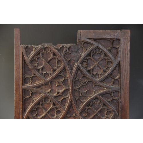 400 - Two early 16th century blind tracery carved panels, of quarteform and triform design, 66cm x 27.5cm ... 