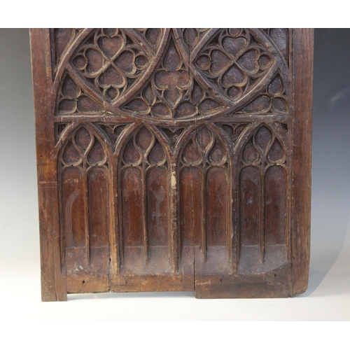 400 - Two early 16th century blind tracery carved panels, of quarteform and triform design, 66cm x 27.5cm ... 