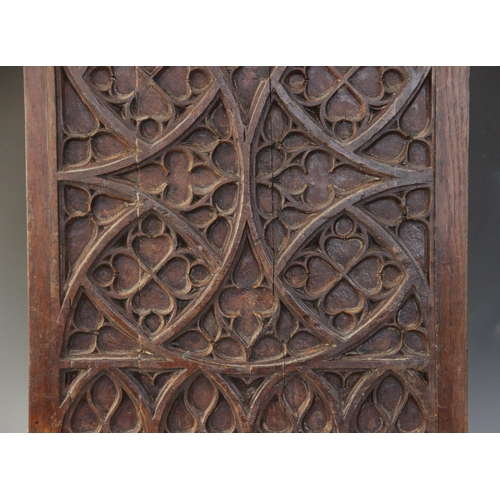 400 - Two early 16th century blind tracery carved panels, of quarteform and triform design, 66cm x 27.5cm ... 