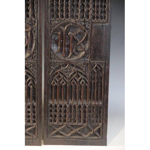 401 - A pair of tracery and christogram type carved panels, circa 1500, elaborately and intricately carved... 