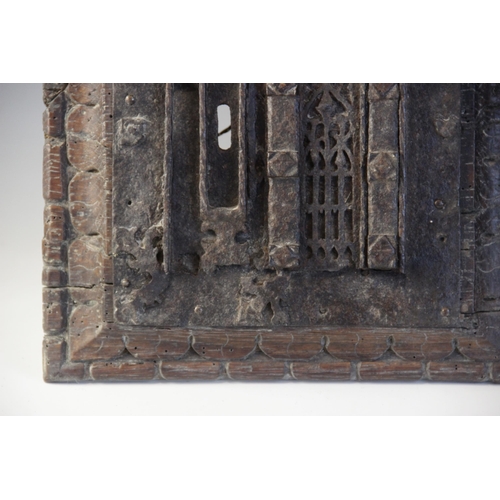 402 - An early 16th century iron lock plate, mounted on a carved oak panel, 19cm x 25.5cm, with a further ... 