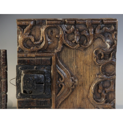 402 - An early 16th century iron lock plate, mounted on a carved oak panel, 19cm x 25.5cm, with a further ... 