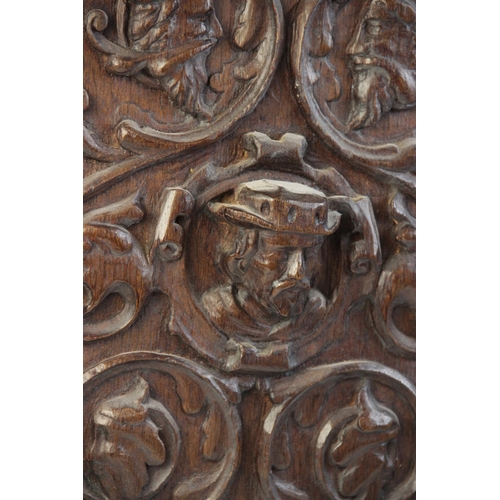 404 - A 16th century carved oak panel, designed as a male in high relief surrounded by scrolling foliage i... 