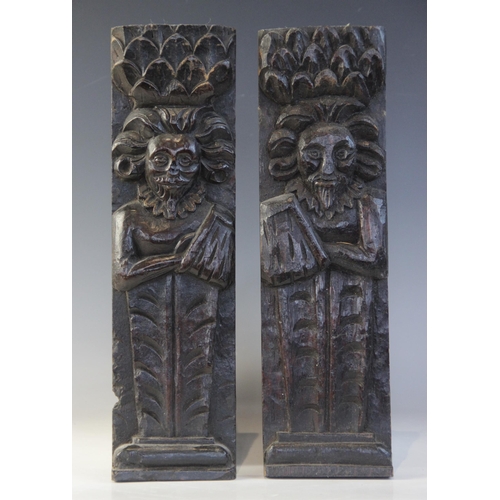 409 - A pair of late Elizabethan figural terms, each carved as a gentleman with his arm in a sling wearing... 