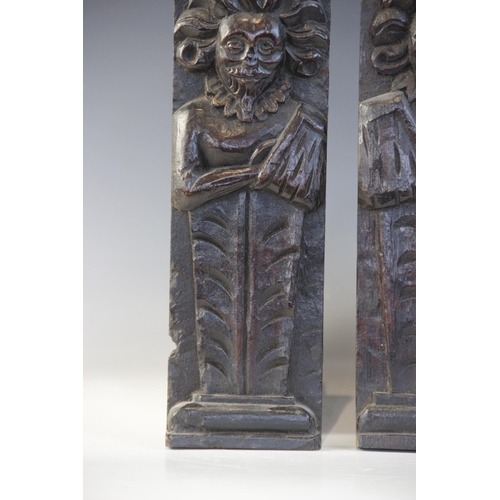 409 - A pair of late Elizabethan figural terms, each carved as a gentleman with his arm in a sling wearing... 