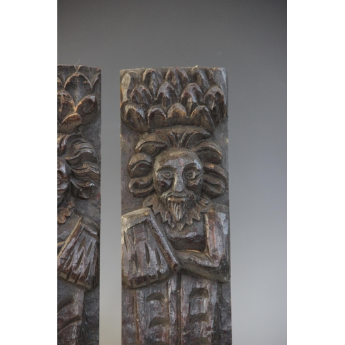 409 - A pair of late Elizabethan figural terms, each carved as a gentleman with his arm in a sling wearing... 