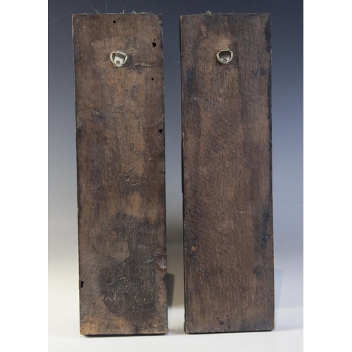 409 - A pair of late Elizabethan figural terms, each carved as a gentleman with his arm in a sling wearing... 