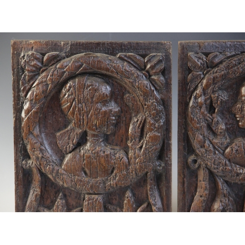 412 - A pair of oak Romayne type panels, each designed with a female holding a single flower within a laur... 