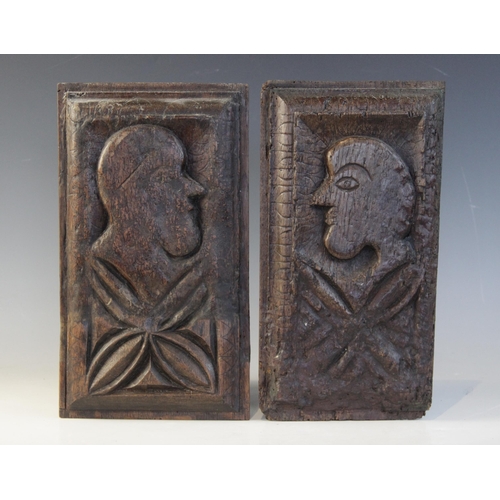 414 - A pair of 16th century oak naïve carved panels, circa 1550, each carved with a profile mask and leaf... 