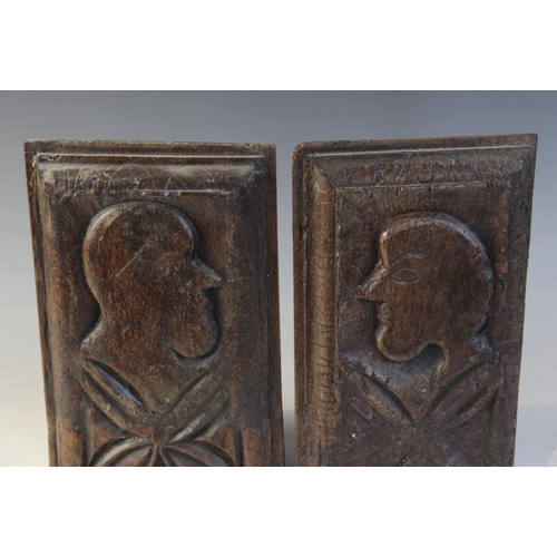 414 - A pair of 16th century oak naïve carved panels, circa 1550, each carved with a profile mask and leaf... 