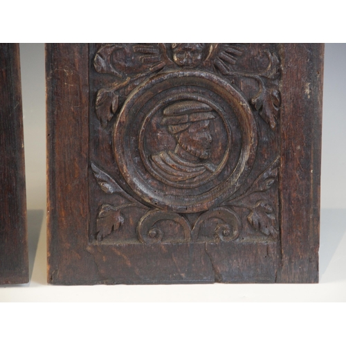 416 - A pair of 16th century carved oak Romayne type panels, Tudor, circa 1530, each carved with a male pr... 