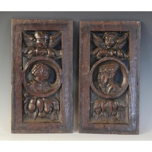 417 - A pair of 16th century oak carved and pierced Romayne type panels, one male, the other female, carve... 