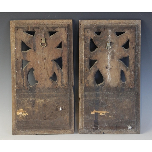 417 - A pair of 16th century oak carved and pierced Romayne type panels, one male, the other female, carve... 