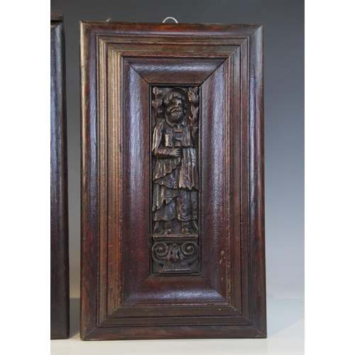 419 - Three carved oak Flemish panels of saints, circa 1600, each Saint carved standing upon a scroll plin... 