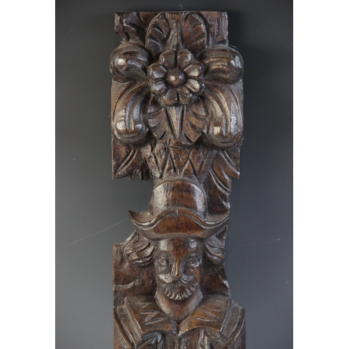 421 - A James I carved oak figural term, carved with a well dressed gentleman modelled standing topped wit... 