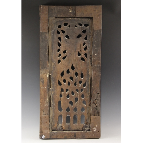 423 - An early 16th century carved oak and pierced tracery panel, circa 1500, the rectangular panel flanke... 