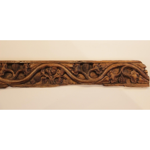 429 - An early 16th century pine frieze, designed with meandering fruiting foliage with central rose and t... 