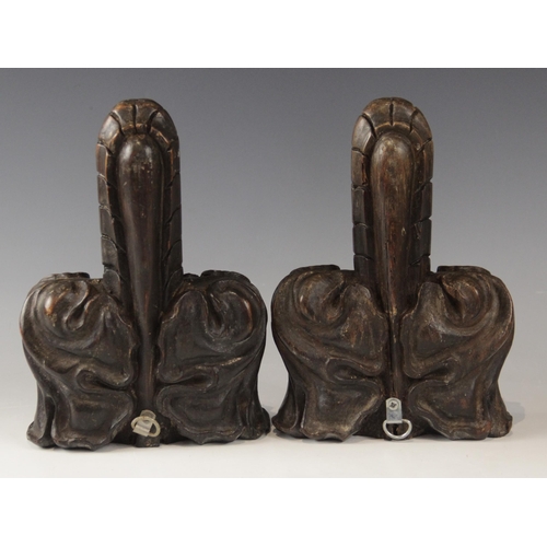 431 - A pair of late 15th century oak poppy head finials, cut from pew ends, 22cm x 15cm (2)