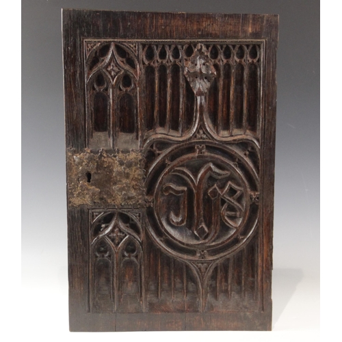 433 - An early 16th century oak tracery carved door, with applied iron lock plate, 57cm high x 37cm wide