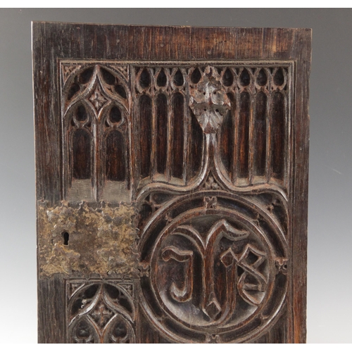 433 - An early 16th century oak tracery carved door, with applied iron lock plate, 57cm high x 37cm wide