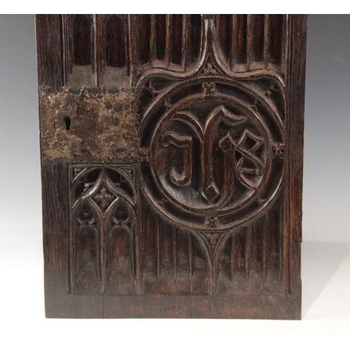 433 - An early 16th century oak tracery carved door, with applied iron lock plate, 57cm high x 37cm wide