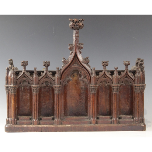 435 - A late 15th century and later carved pine niche, designed with nine tracery surrounds, with cluster ... 