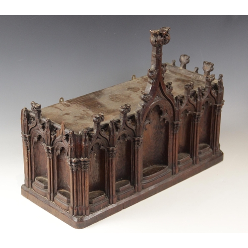 435 - A late 15th century and later carved pine niche, designed with nine tracery surrounds, with cluster ... 