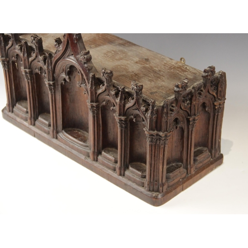 435 - A late 15th century and later carved pine niche, designed with nine tracery surrounds, with cluster ... 