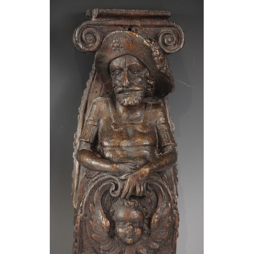 436 - A pair of 17th century oak figural terms, Flemish, each carved with a male bust wearing a hat above ... 