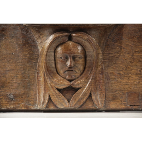 437 - A late 15th century carved oak misericord, carved with a central green man below the seat, 48cm high... 