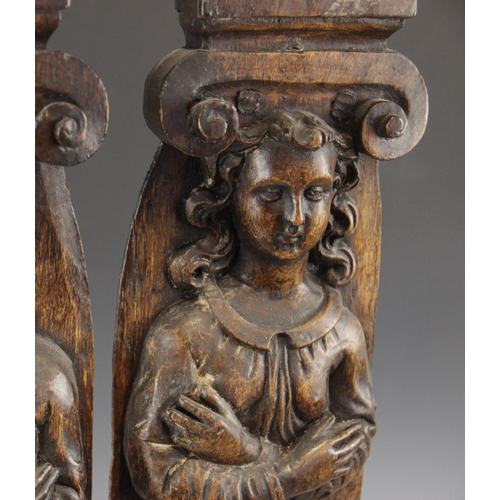 440 - A pair of 17th century carved oak figural terms, Flemish, one male, the other female, both with fold... 