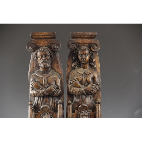 440 - A pair of 17th century carved oak figural terms, Flemish, one male, the other female, both with fold... 