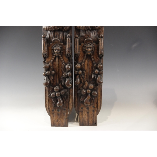 440 - A pair of 17th century carved oak figural terms, Flemish, one male, the other female, both with fold... 