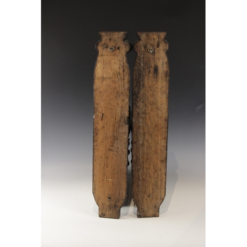 440 - A pair of 17th century carved oak figural terms, Flemish, one male, the other female, both with fold... 