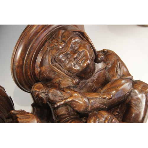 442 - A pair of walnut beam ends, in the 16th century manner, one modelled as a jester the other a musicia... 